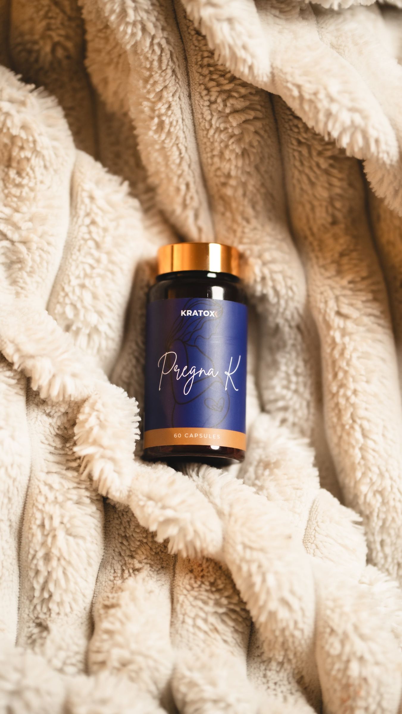 Pregna K nestled in a knitted blanket