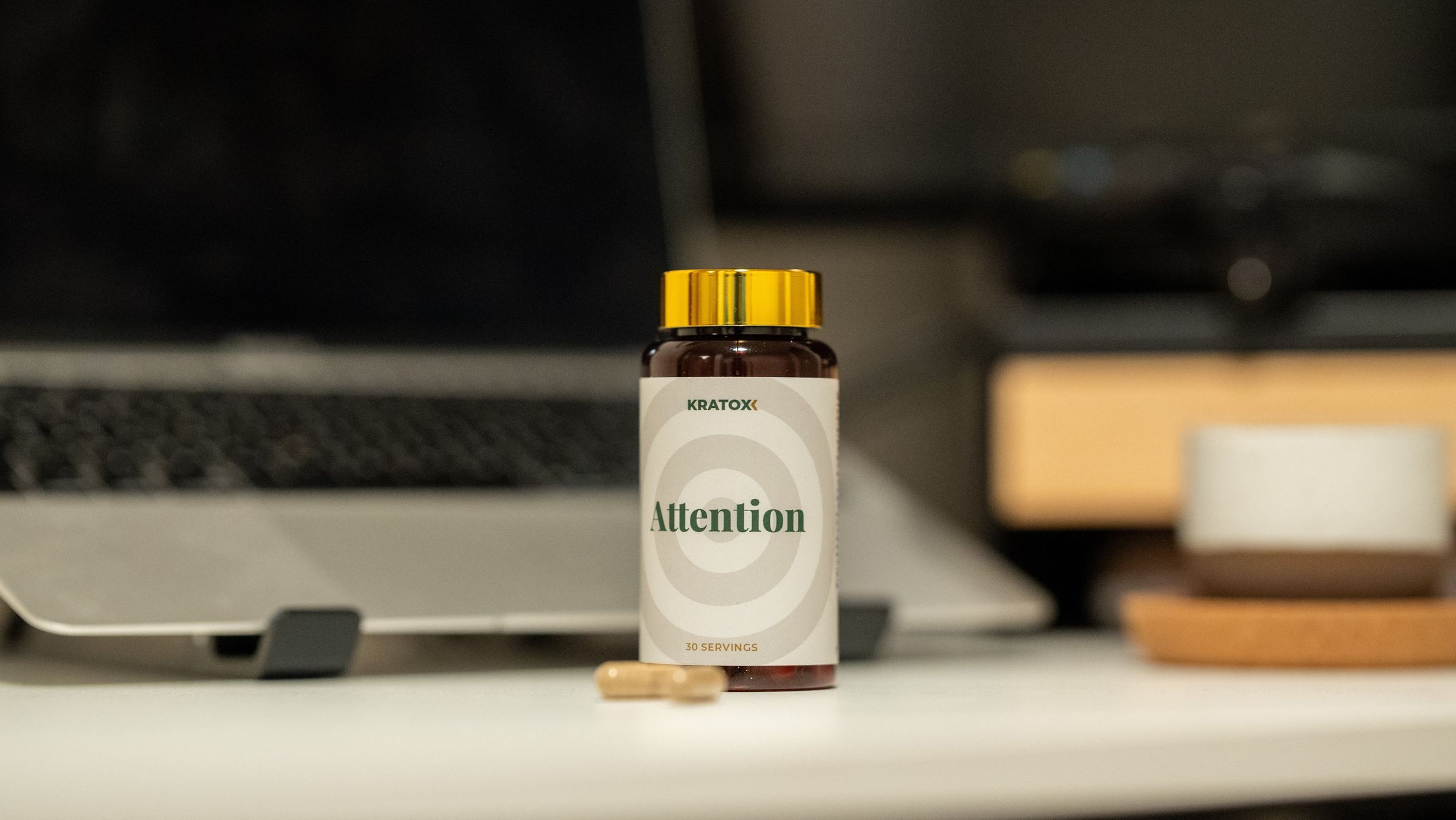 Attention product beside a laptop