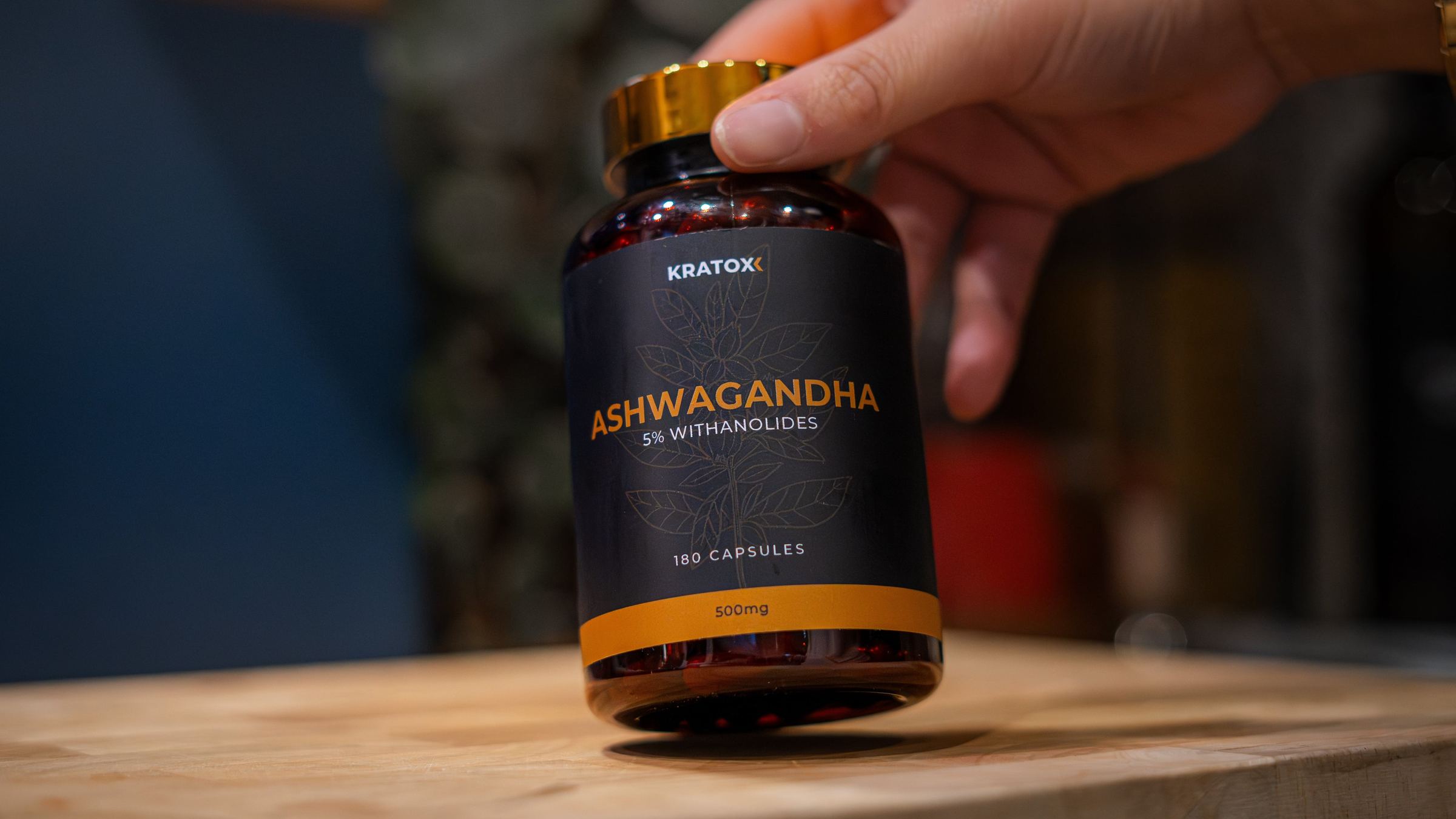 Ashwagandha bottle held at a table