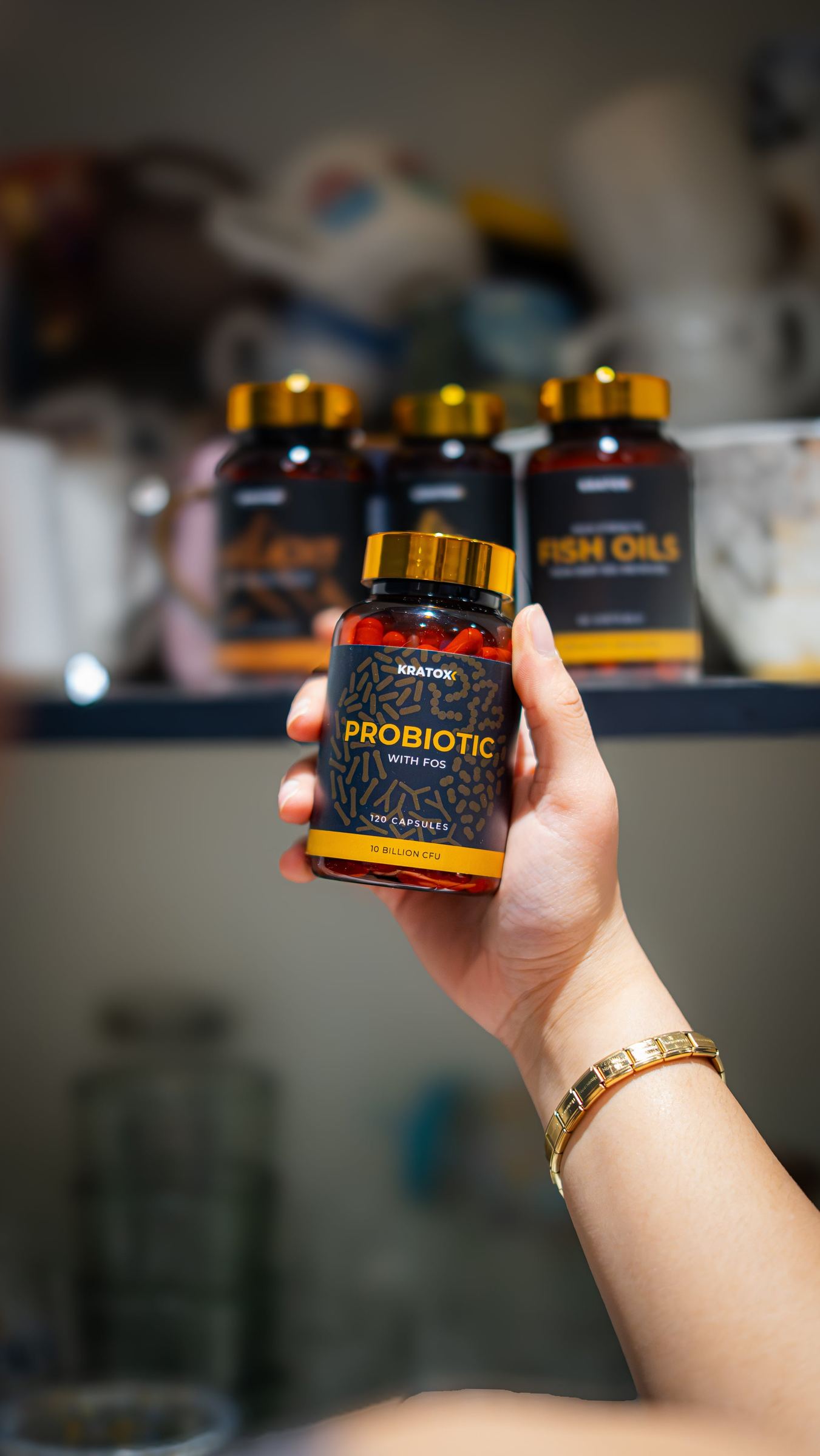 Hand presenting a Probiotic bottle from the product range