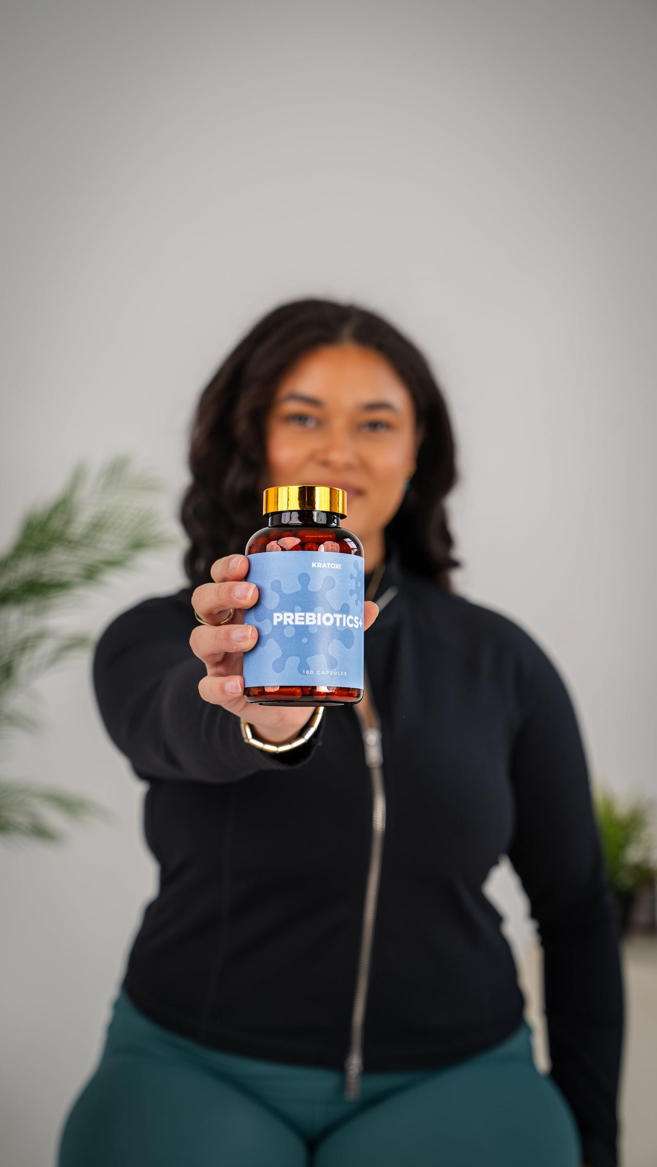 Studio portrait holding blue AOB gummies