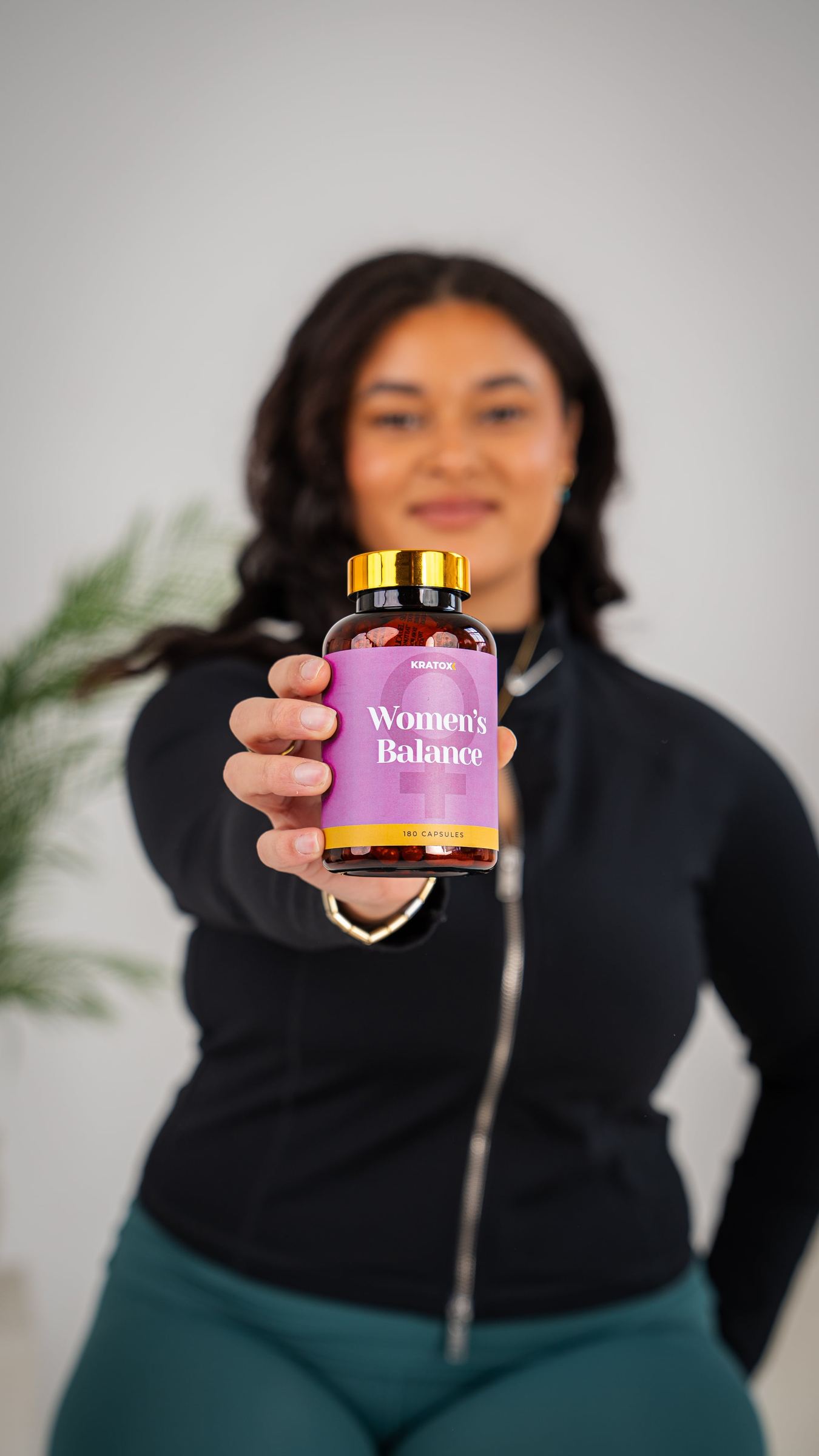 Studio portrait holding purple AOB gummies