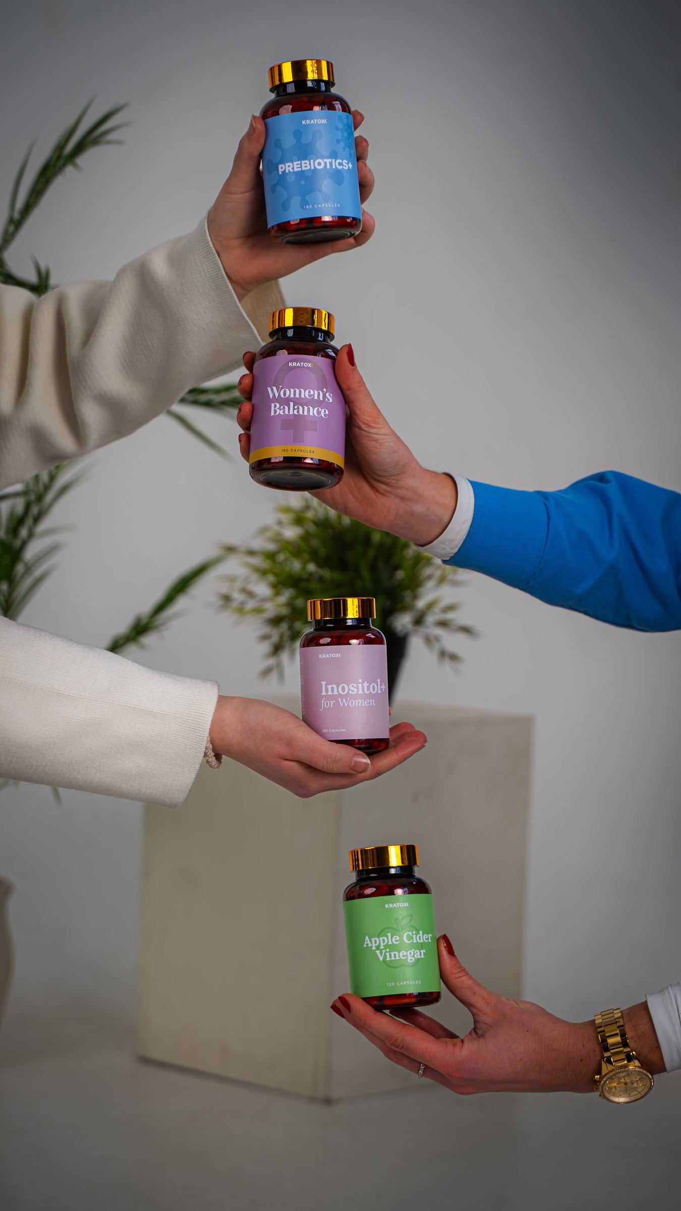 Hands lifting a stack of colourful AOB products
