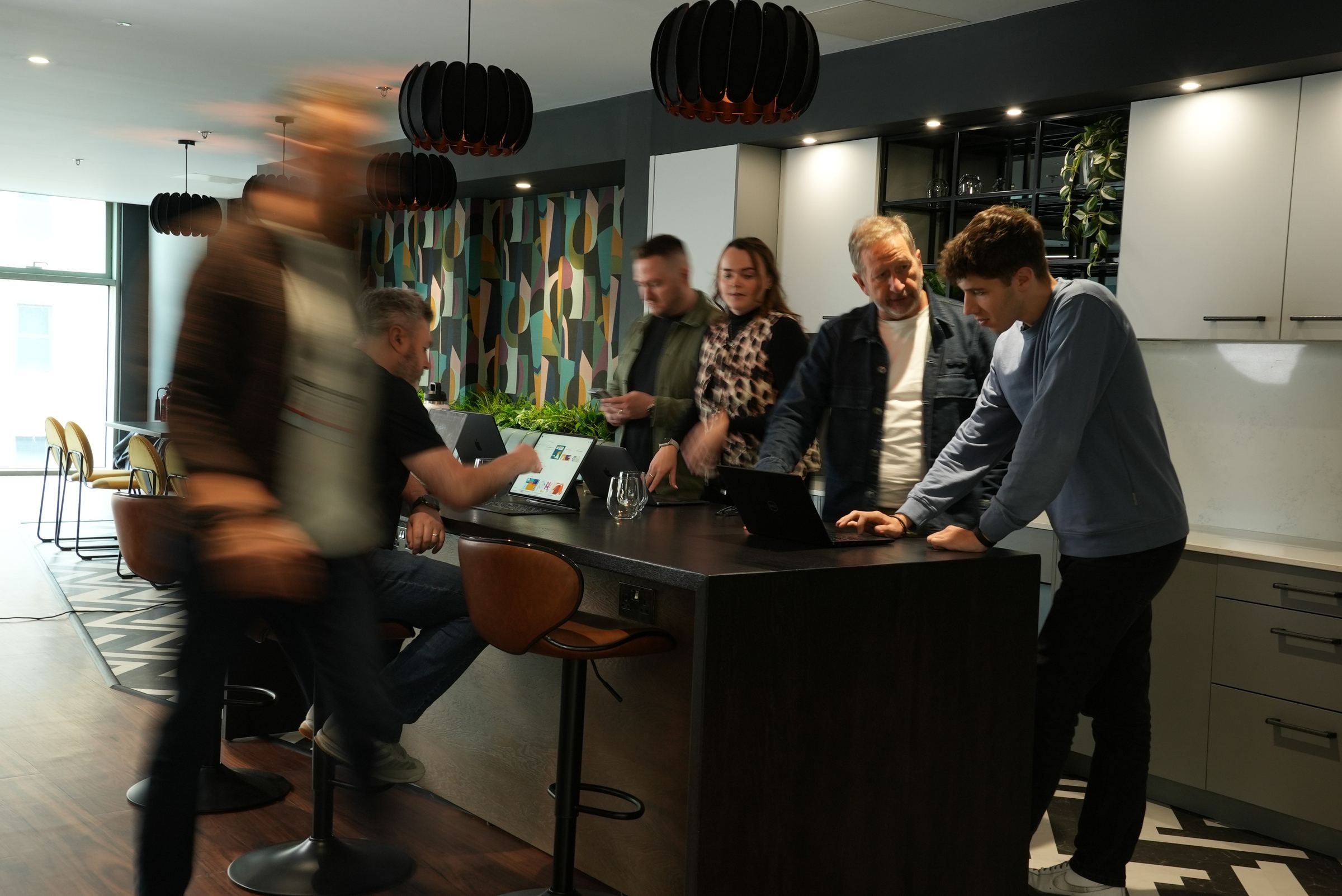 The team collaborating around the kitchen island
