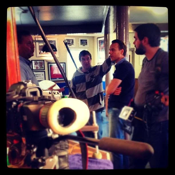 Production team preparing a pub location scene