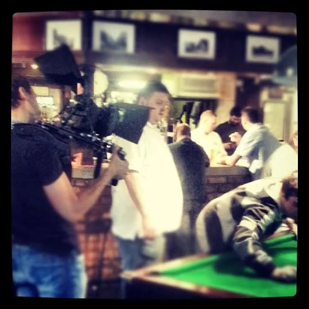 Camera crew filming an alcohol campaign in a pub