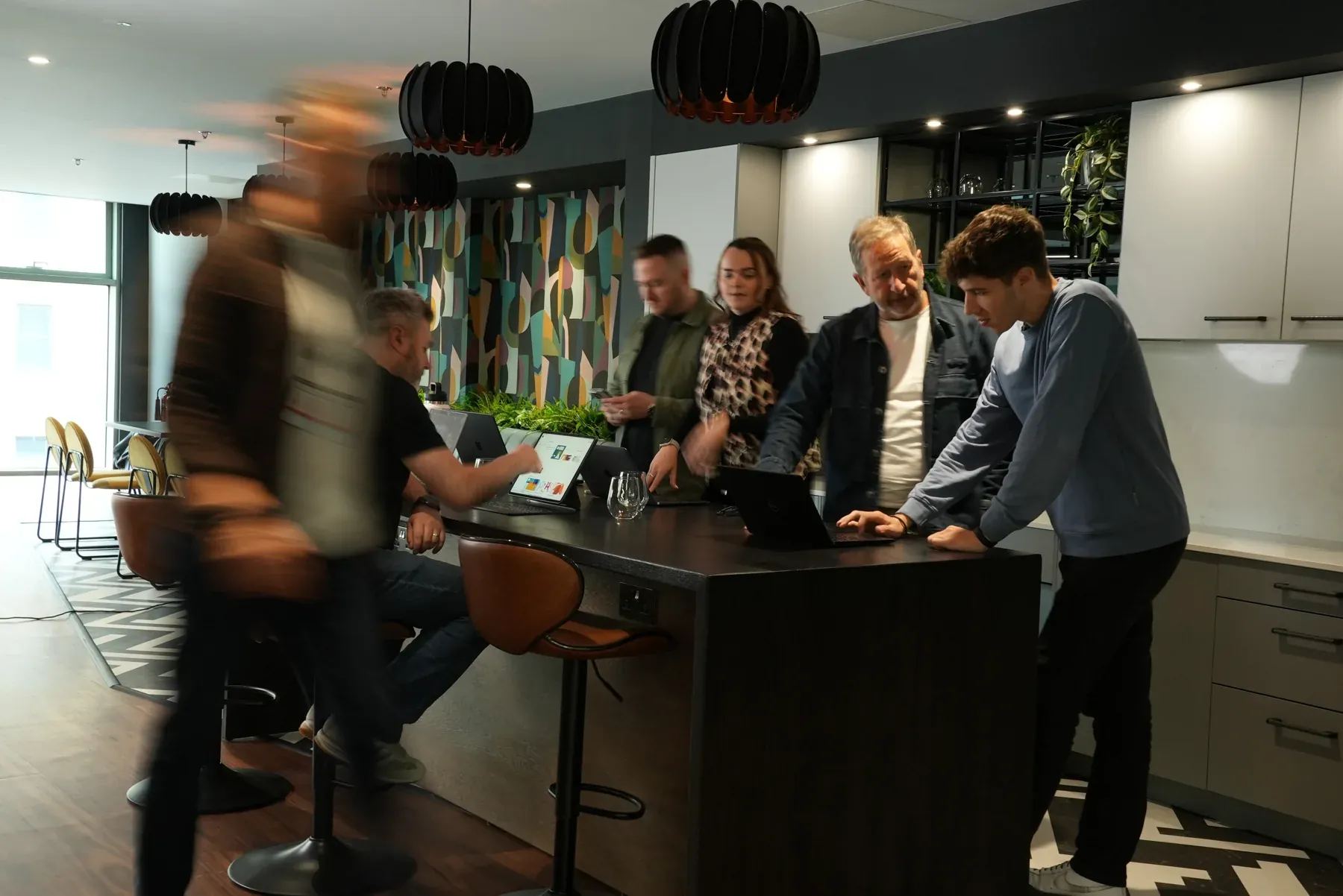 Team gathered around a high table in the office