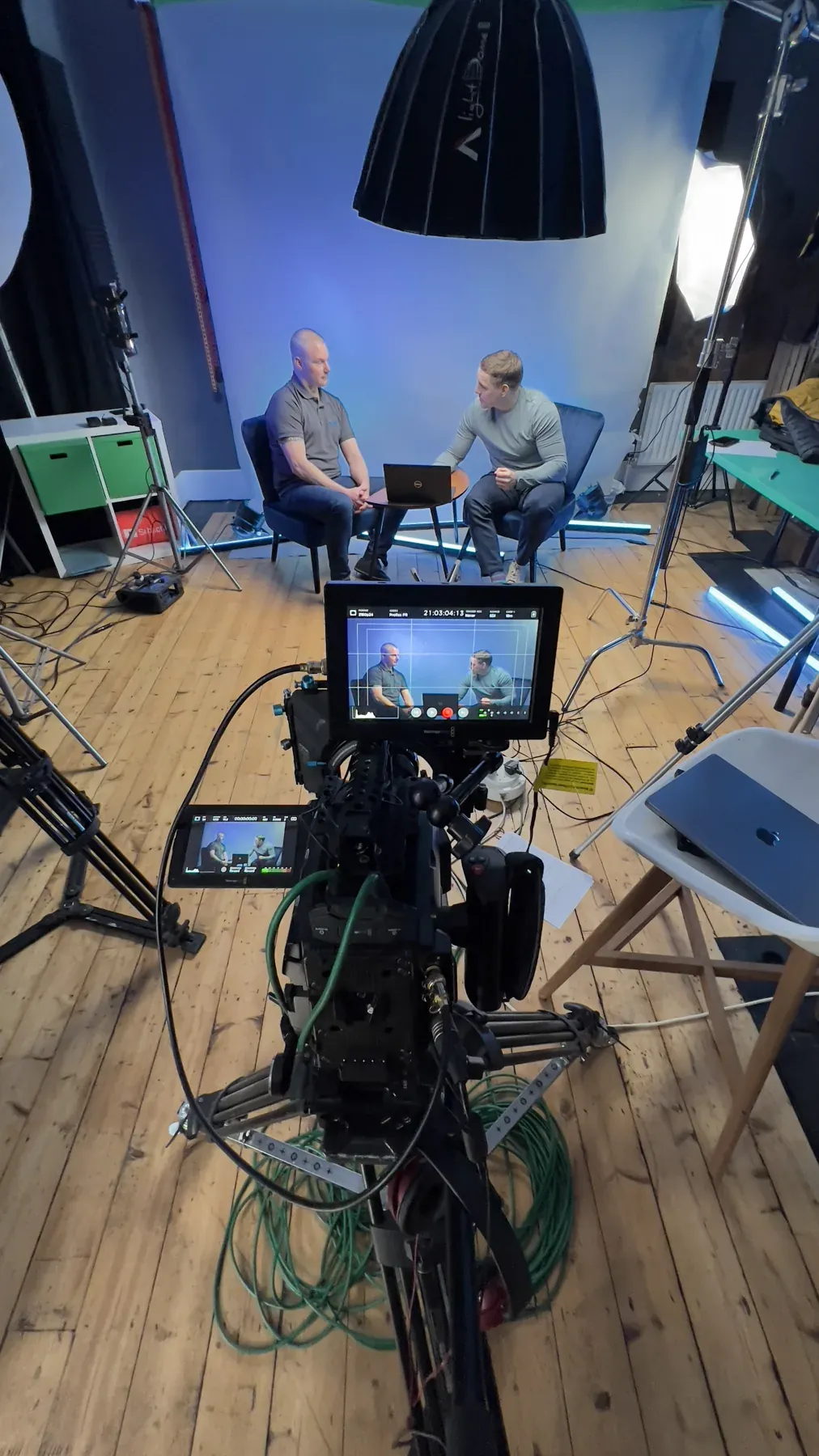 Production camera set up inside a bright interior