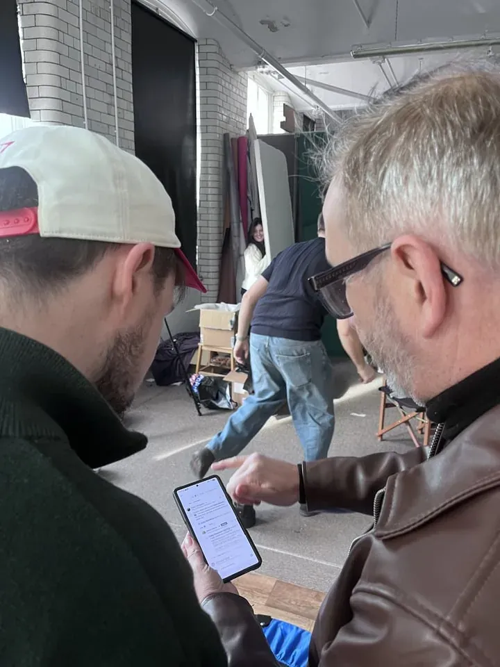 Crew reviewing footage together beside a camera