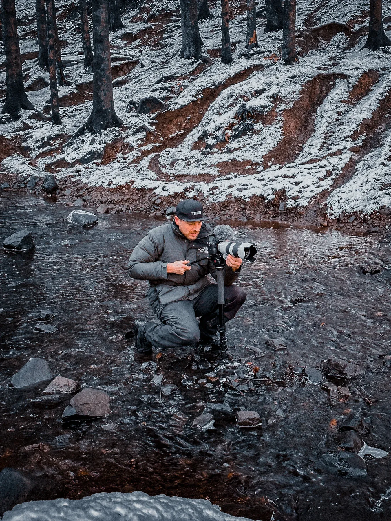 Camera operator on a rocky outdoor location