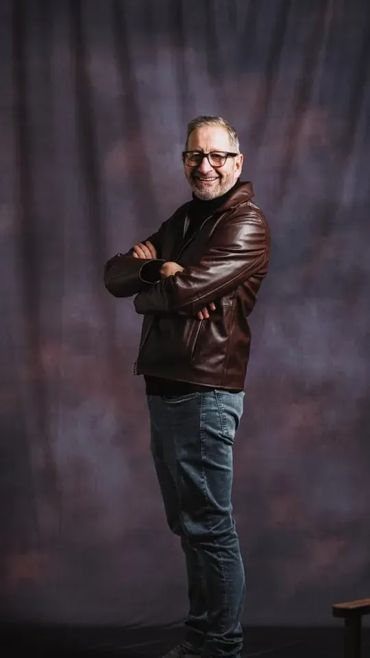Portrait lit against a dark studio backdrop