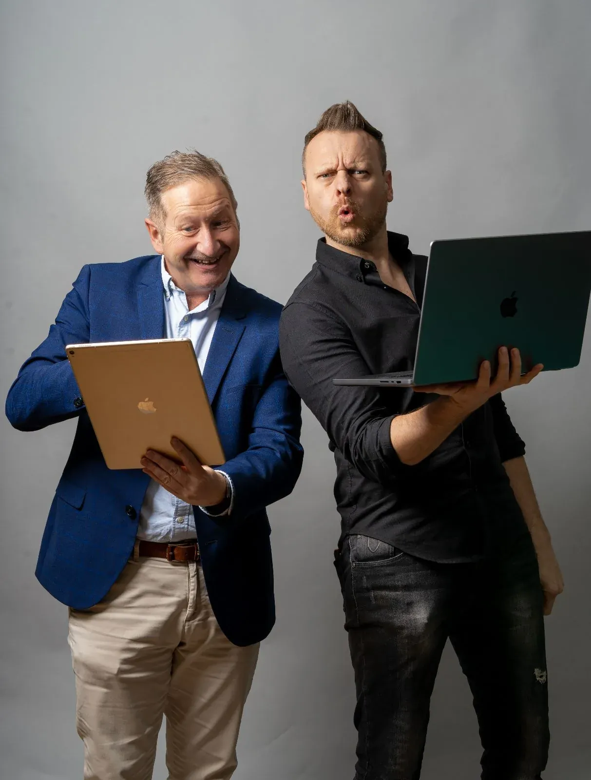 Two team members holding tablets in a portrait session