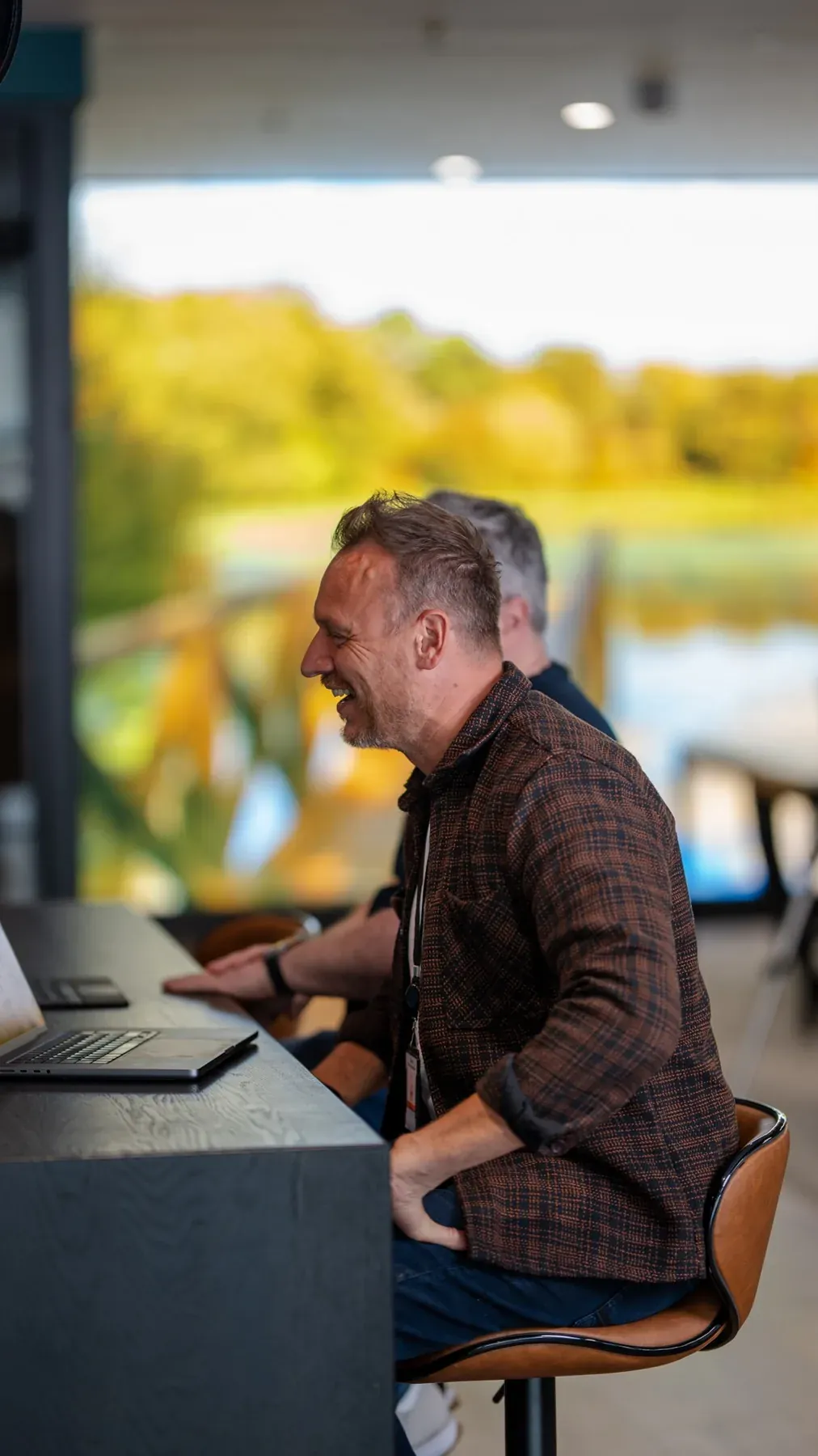 Team member working at a desk beside a window